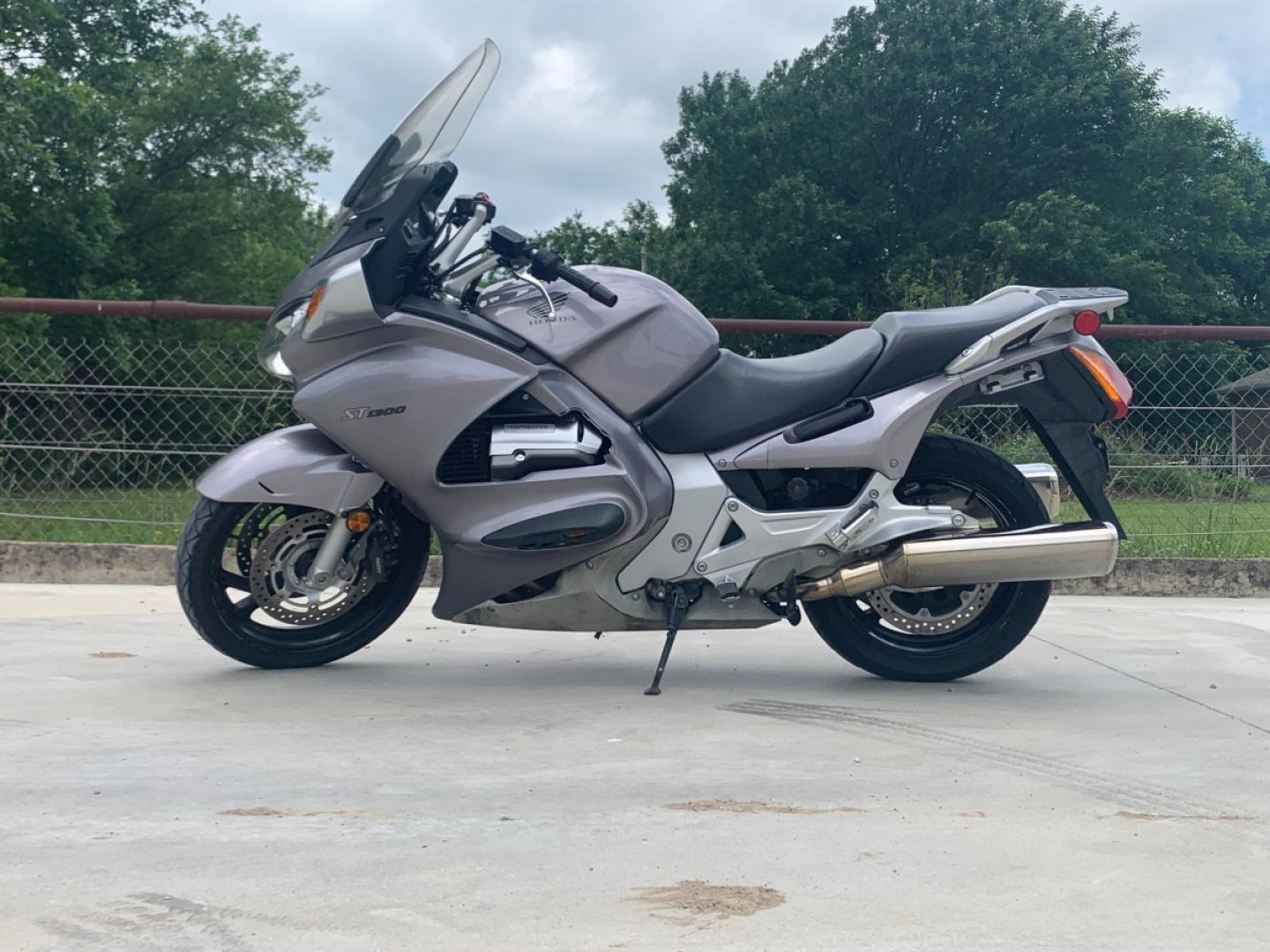 2003 Silver Honda ST1300 ST1300 (JH2SC51103M) with an 1261CC engine, 5 SPEED transmission, located at 17760 HWY 62, MORRIS, 74445, 35.609104, -95.877060 - 2003 HONDA ST1300 1261CC 5-SPEED TRANSMISSION WITH AN ELECTRIC START, POWER-ADJUSTABLE LIGHTS, POWER-ADJUSTABLE WINDSHIELD, NICE CLEAN TOURING SPORTS BIKE. ONLY 17,093 MILES, MARATHON TIRES, IT HAS REBUILT TITLE DUE TO A SMALL ACCIDENT. LIGHT SCRAPES AS SHOWN IN PICTURES. WE OFFER A FREE CARFAX ON - Photo#0