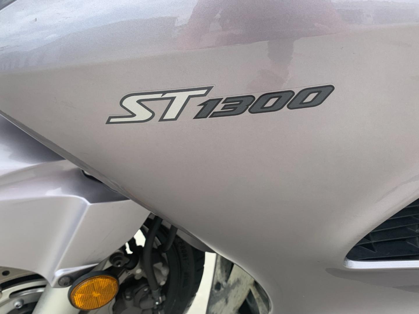 2003 Silver Honda ST1300 ST1300 (JH2SC51103M) with an 1261CC engine, 5 SPEED transmission, located at 17760 HWY 62, MORRIS, 74445, 35.609104, -95.877060 - 2003 HONDA ST1300 1261CC 5-SPEED TRANSMISSION WITH AN ELECTRIC START, POWER-ADJUSTABLE LIGHTS, POWER-ADJUSTABLE WINDSHIELD, NICE CLEAN TOURING SPORTS BIKE. ONLY 17,093 MILES, MARATHON TIRES, IT HAS REBUILT TITLE DUE TO A SMALL ACCIDENT. LIGHT SCRAPES AS SHOWN IN PICTURES. WE OFFER A FREE CARFAX ON - Photo#7