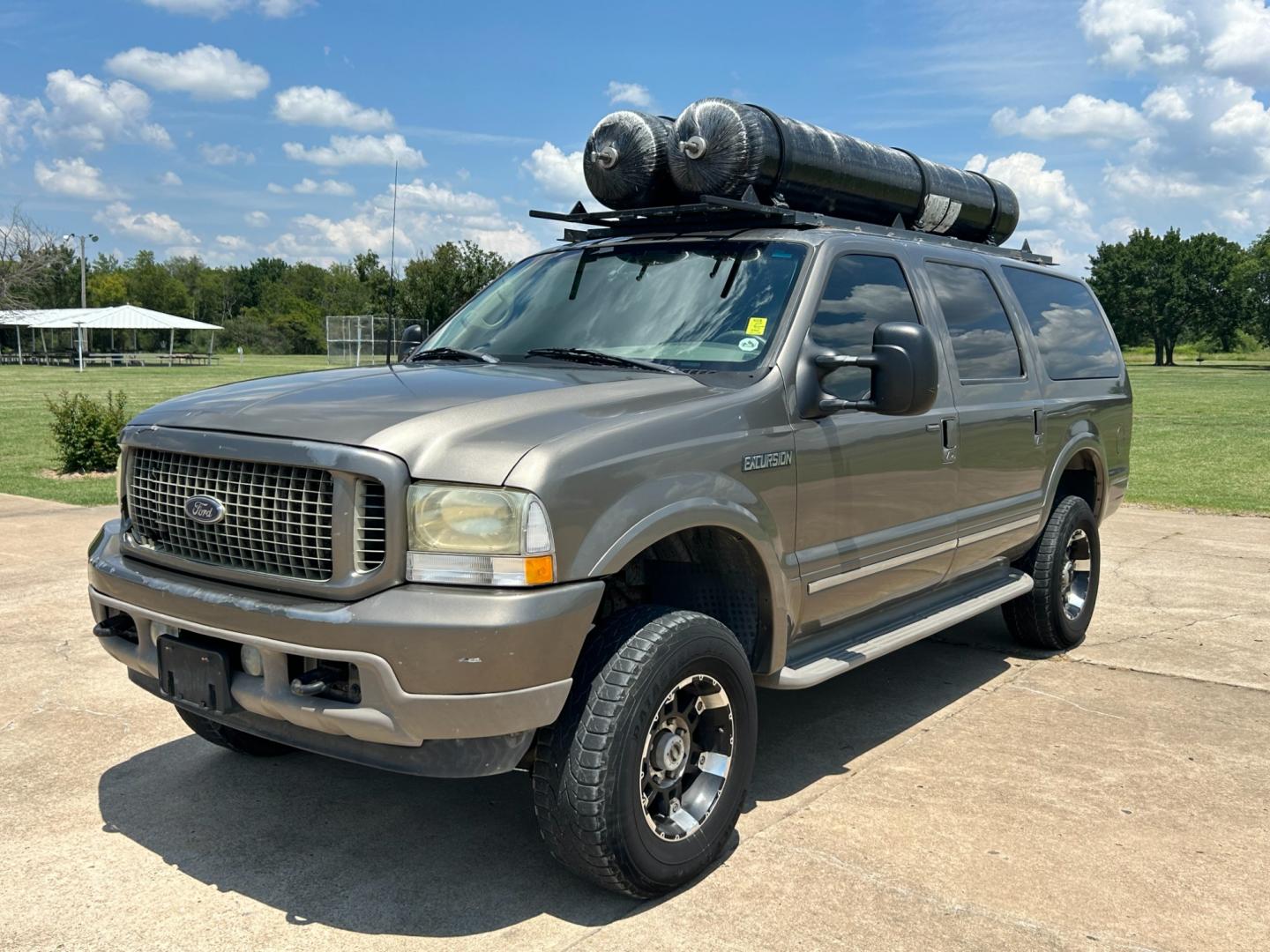 2002 GRAY /TAN Ford Excursion LIMITED (1FMNU43S32E) with an 6.8L V10 engine, AUTOMATIC transmission, located at 17760 Hwy 62, Morris, OK, 74445, (918) 733-4887, 35.609104, -95.877060 - 2002 FORD EXCURSION BI-FUEL SYSTEM (RUNS ON CNG OR GASOLINE) HAS THE 6.8L V10 ENGINE AND IS 4WD. IT FEATURES POWER SEATS, POWER LOCKS, POWER WINDOWS, POWER MIRROR, LEATHER INTERIOR, 3RD ROW SEATING, TILT WHEEL, ADJUSTABLE FOOT PEDAL, AM/FM RADIO AND CD PLAYER, A/C AND HAS REAR A/C. MILES 209,025 ** - Photo#0