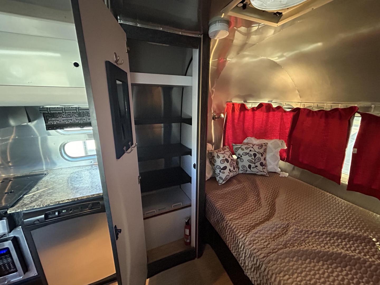 2005 Silver Airstream INTERNATIONAL 25CCD 25CCD (1STBFAF235J) , located at 17760 Hwy 62, Morris, OK, 74445, 35.609104, -95.877060 - LET THE ADVENTURES BEGIN WITH THIS 2005 22FT AIRSTREAM INTERNATIONAL. IN THE FRONT IS THE BEDROOM WITH A FULL SIZE BED AND STORAGE UNDER THE BED, TV ON A MOUNT WITH DVD PLAYER, CLOSET/PANTRY, IN THE KITCHEN AND LIVING AREA IS A MINI FRIDGE, 3 BURNER STOVE (NO OVEN), MICROWAVE, STAINLESS STEEL SINK A - Photo#12